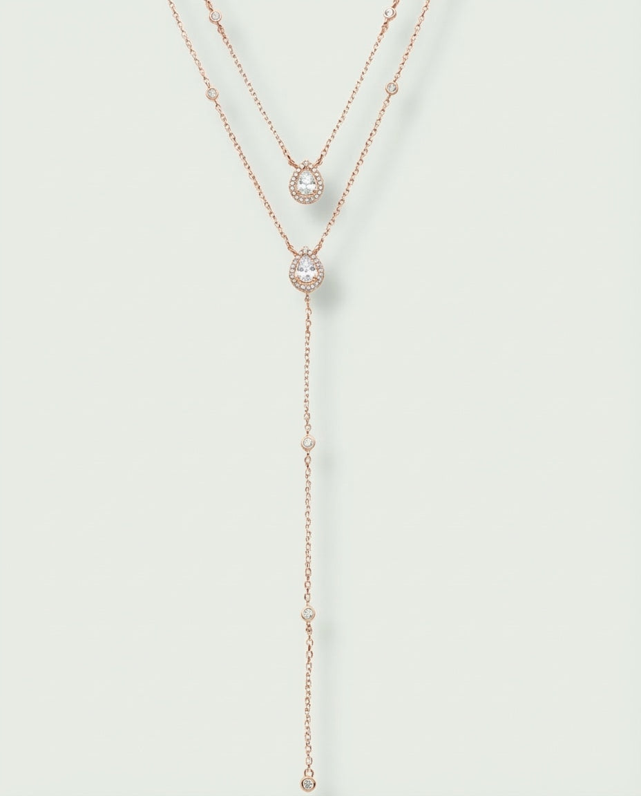 Sautoir « Double Infini Poire » en argent 925 doré à l’or rose 18 carats, double rang dont un rang choker orné de pierres en zirconium taille poire, finition polie brillante.