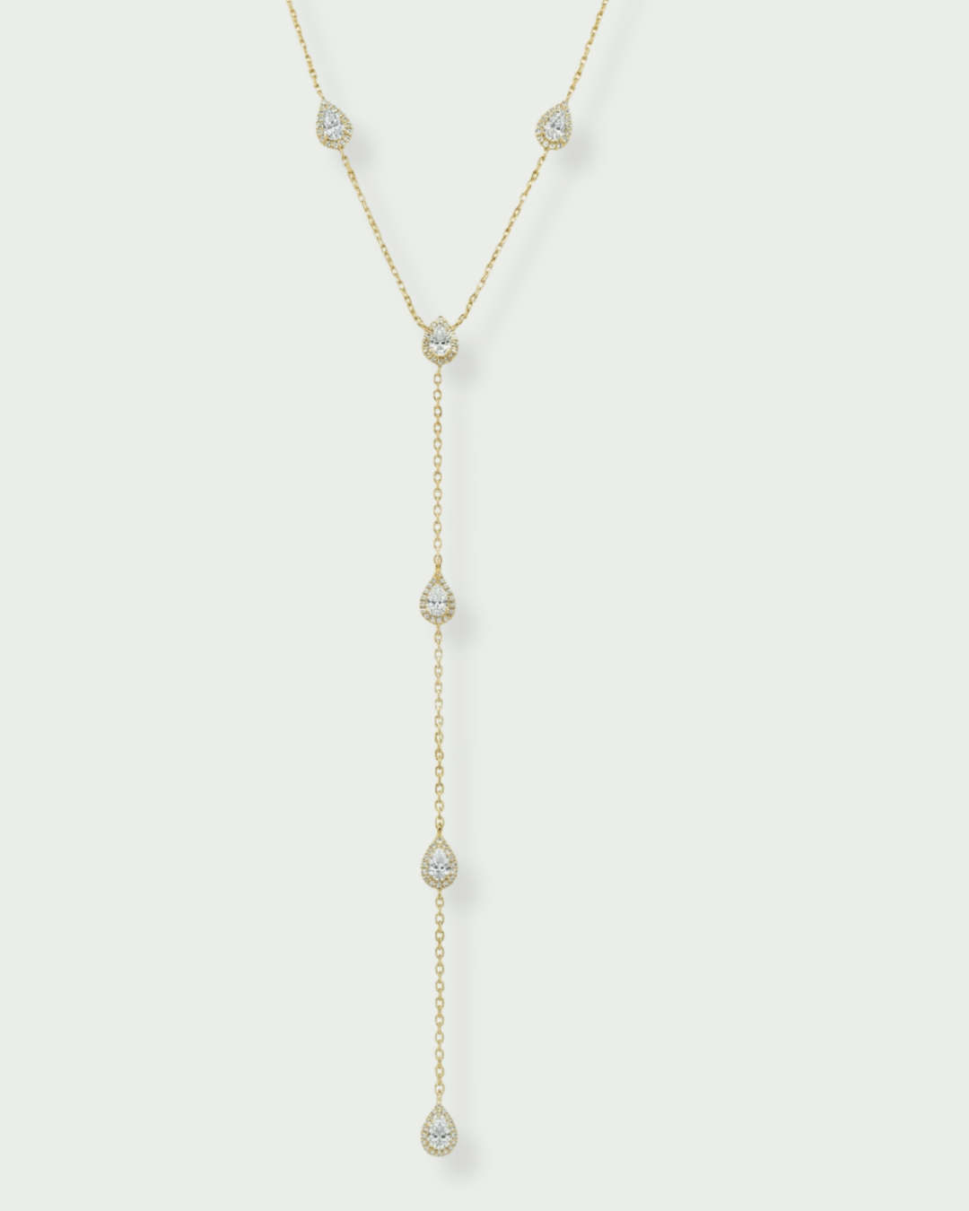 Collier « Sautoir Infini Poire » en argent 925 doré à l’or jaune 18 carats, chaîne ajustable 38‑43 cm avec chute verticale d’environ 12 cm, ornée de zircons blancs taille poire sertis façon halo, finition polie brillante.