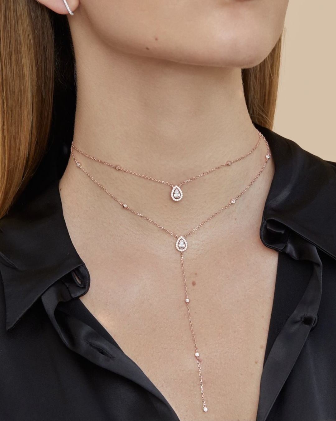 Sautoir « Double Infini Poire » en argent 925 doré à l’or rose 18 carats, double rang dont un rang choker orné de pierres en zirconium taille poire, finition polie brillante.