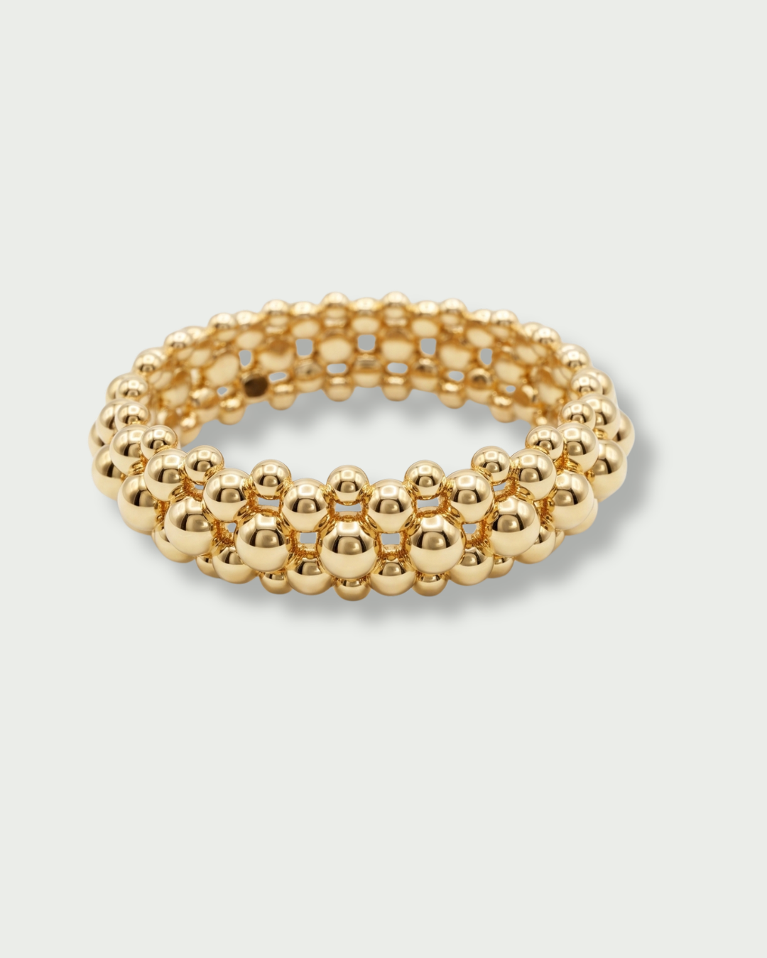 Bague Perle Boost en argent 925 doré a l'or jaune 18 carats, composée de plusieurs rangées ajourées de perles métalliques de différentes tailles.