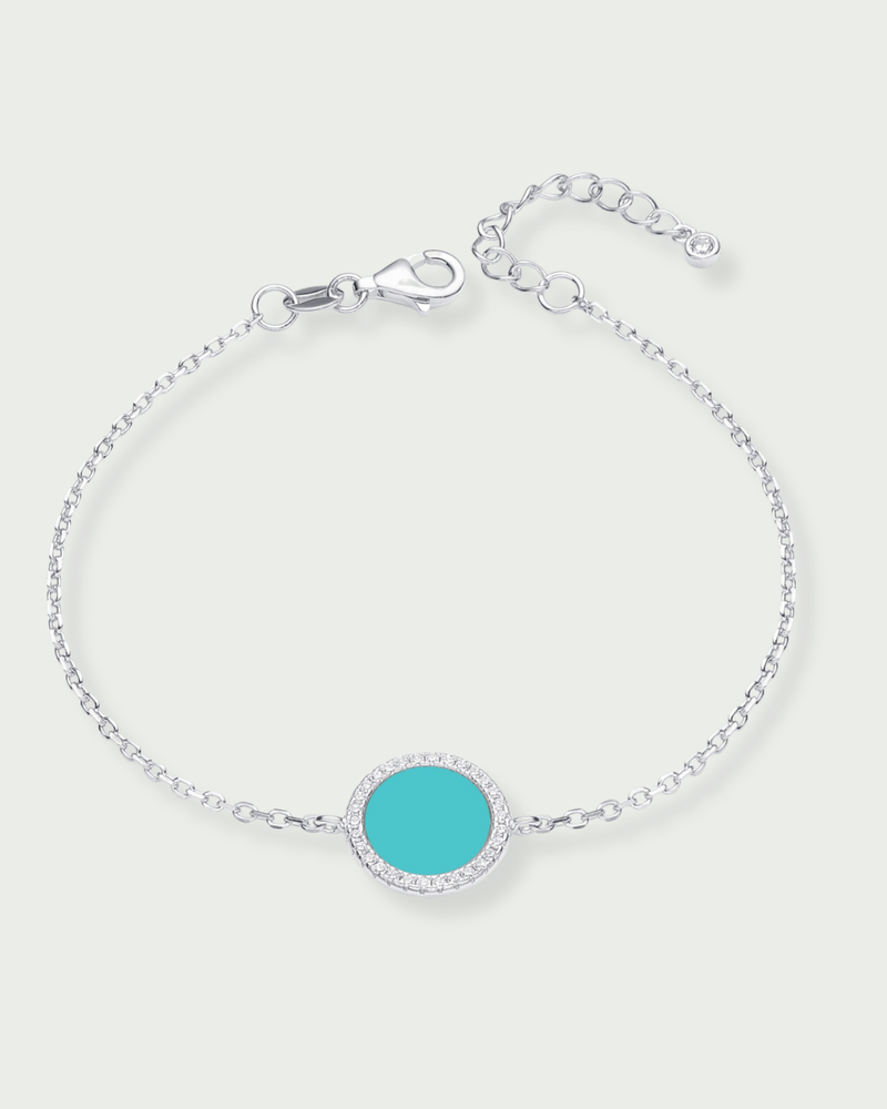 Bracelet en argent 925 rhodié, orné d’une petite médaille ronde sertie d’une pierre turquoise, finition polie brillante.
