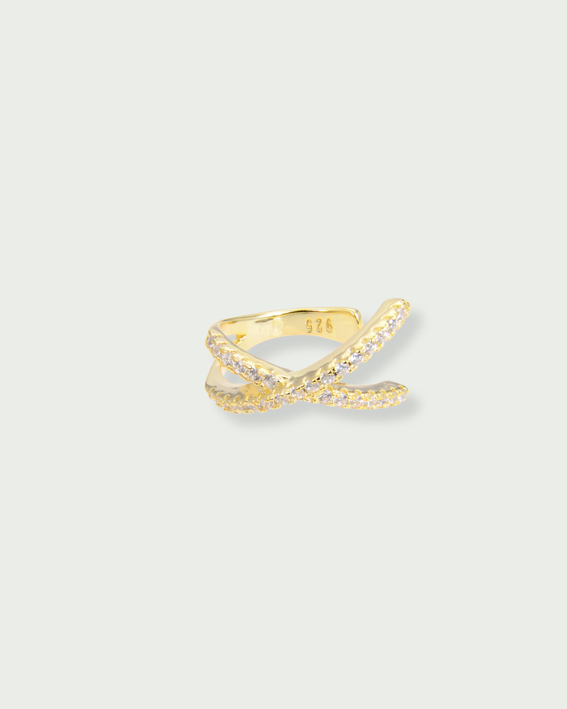 Earcuff Croisé Intemporel – Doré en argent 925 doré à l’or 18 carats, lignes entrelacées au design structuré et contemporain, finition lumineuse résistante à l’oxydation, format ajustable à clipser sans piercing, conçu pour habiller l’oreille d’une touche solaire et architecturale, à porter seul ou en accumulation.
