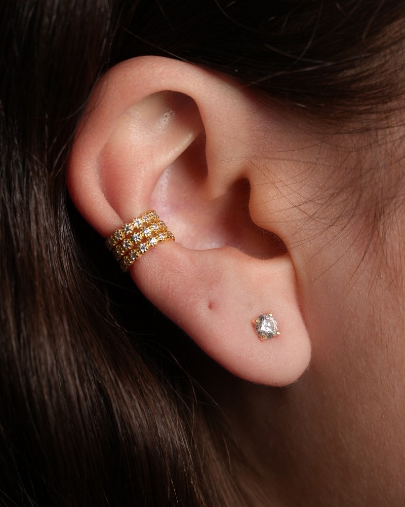 Earcuff Pur Intemporel – Doré en argent 925 doré à l’or 18 carats, silhouette lisse et minimaliste sans serti pour une esthétique pure et contemporaine, finition lumineuse résistante à l’oxydation, design ajustable à clipser sans piercing, imaginé pour structurer l’oreille d’une touche solaire et sophistiquée, du quotidien aux compositions les plus audacieuses.
