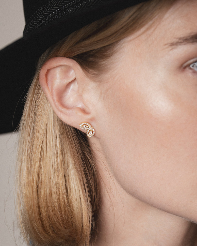 Boucles d’oreilles puces « Demi Fleur de Vie » en argent 925 doré à l’or jaune 18 carats, motif floral minimaliste sublimé par deux pierres taille marquise et un pavage de zirconiums taille ronde, finition polie brillante.