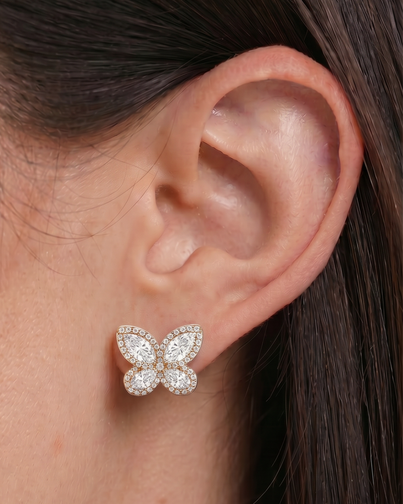 Gros plan sur les puces Papillon en argent 925 doré à l'or rose 18 carats - porté 