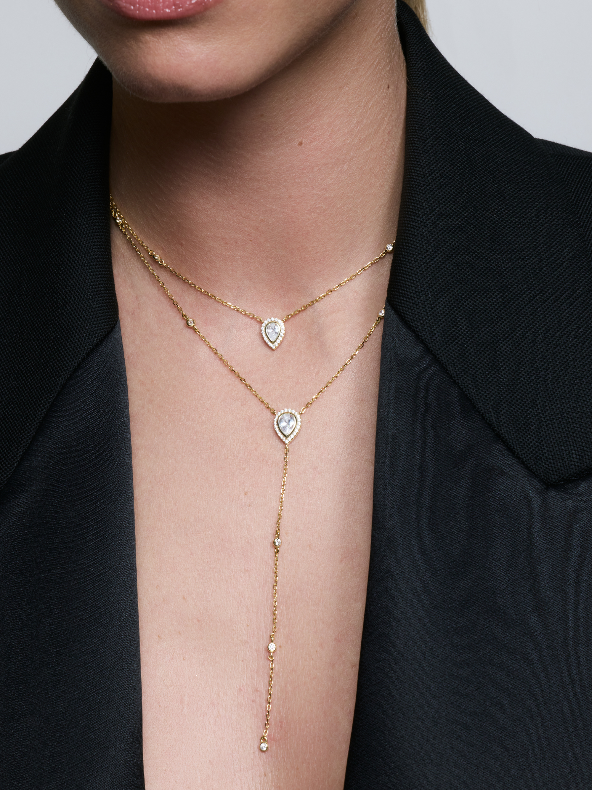 
Sautoir double Signature doré en argent 925 plaqué or 18 carats, avec deux chaînes fines et pendentifs en zirconium taille poire, design en Y élégant qui illumine le décolleté.